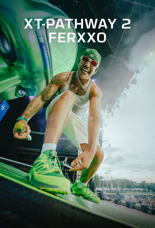 Person in green shoes and outfit with 'XT-PATHWAY 2 FERXXO' text on a car interior background